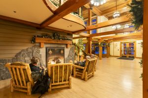 Guests sitting by the fireplace at Old Faithful Snow Lodge