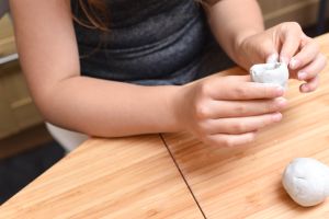 Girl making pottery with white clay