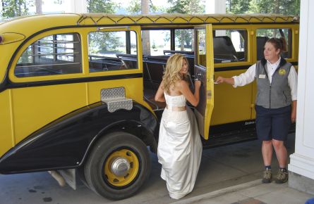 Bride getting into a historic yellow bus
